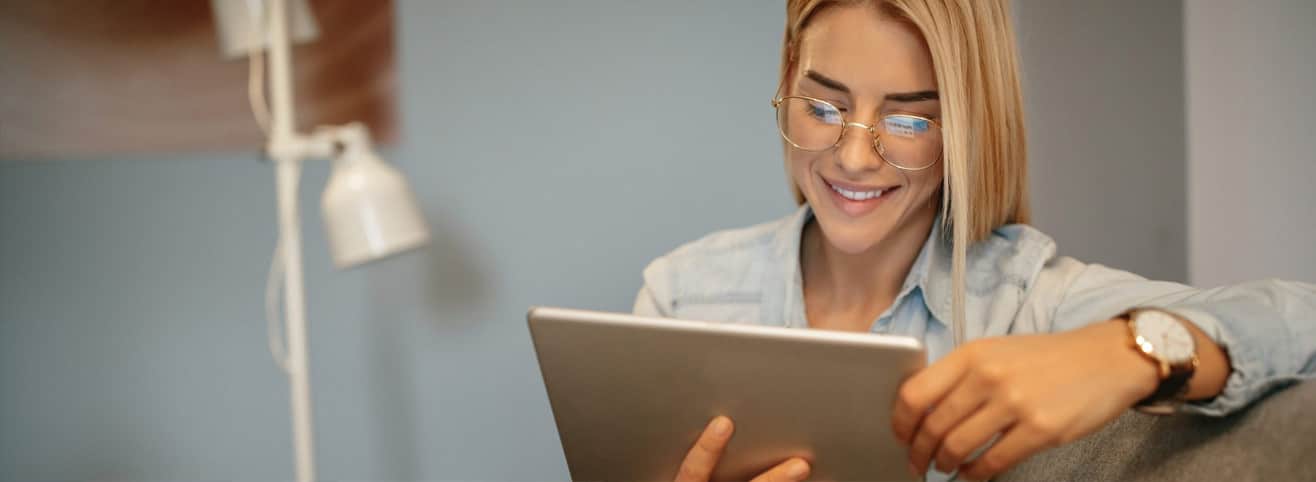 blonde woman reading tablet